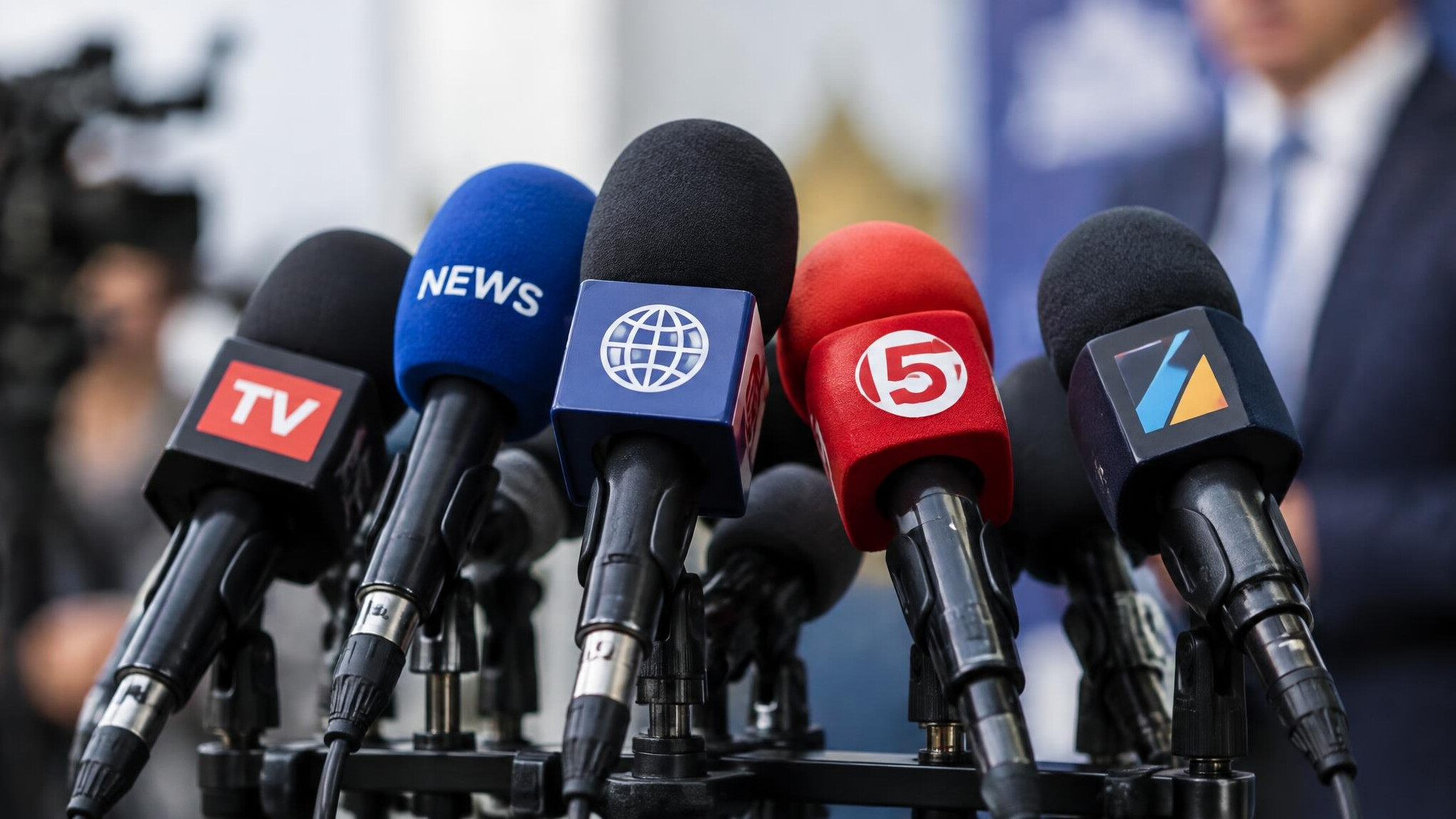 Several press microphones at an interview event