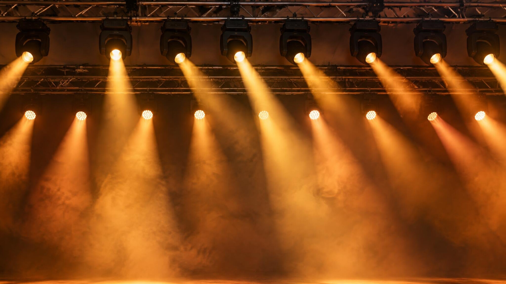Stage lighting fixtures above a stage
